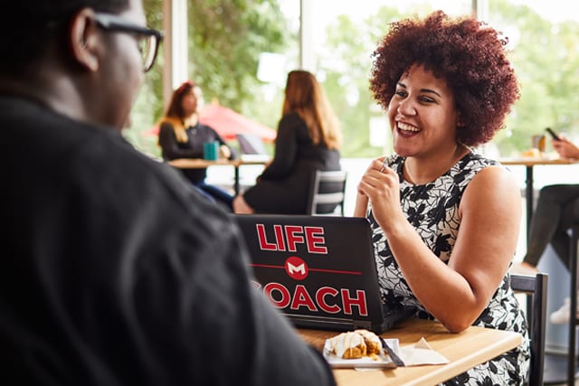 Life Coach and student on campus