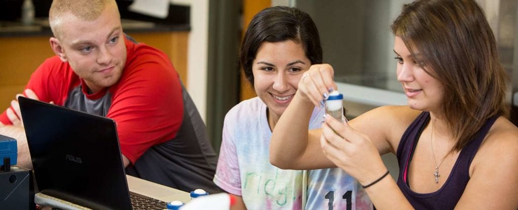 students performing science experiement