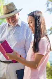 professor helping student on ipad