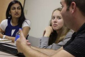 students listening to faculty member