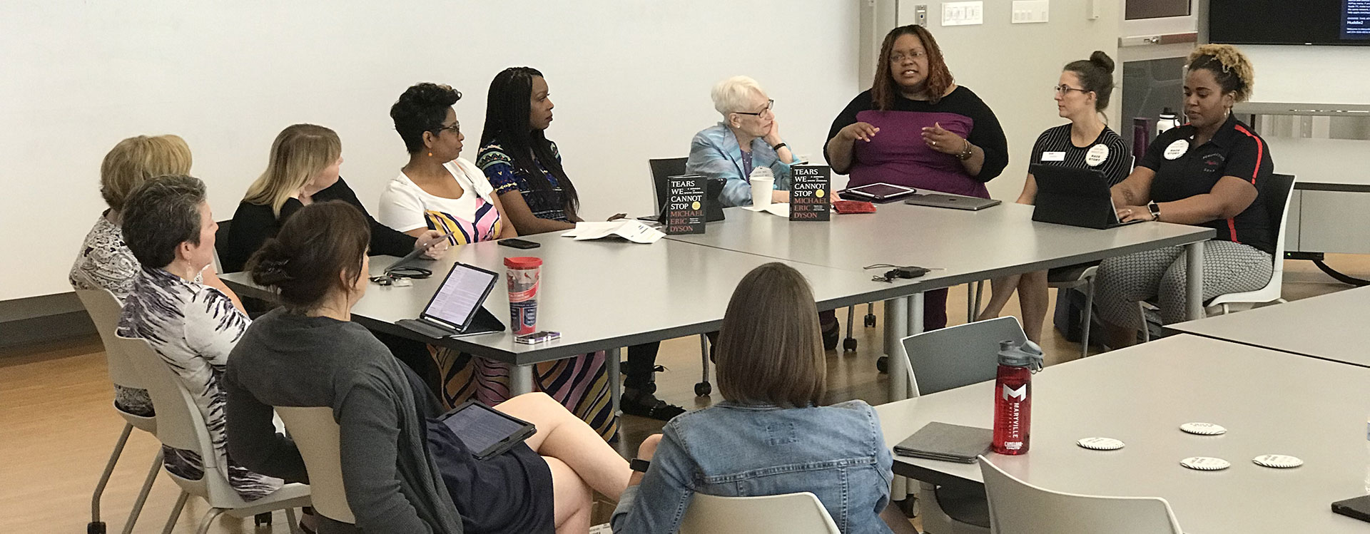 Maryville University faculty in a training discussion