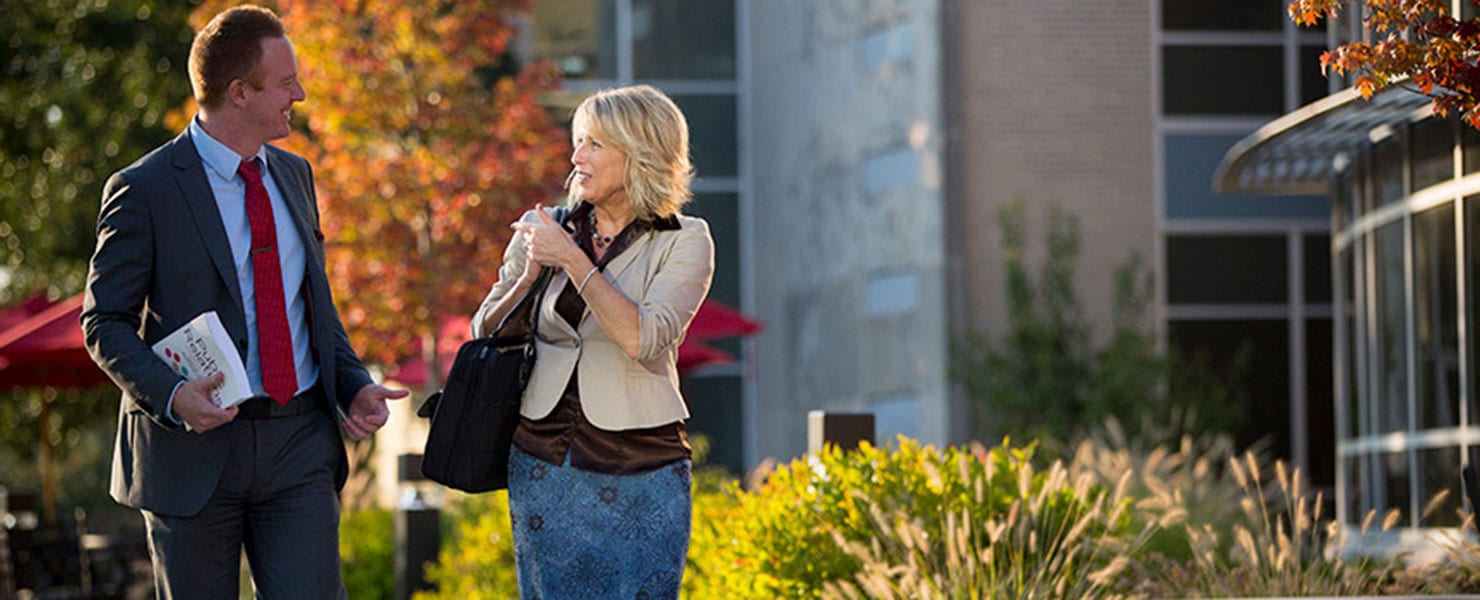 A couple walking across campus