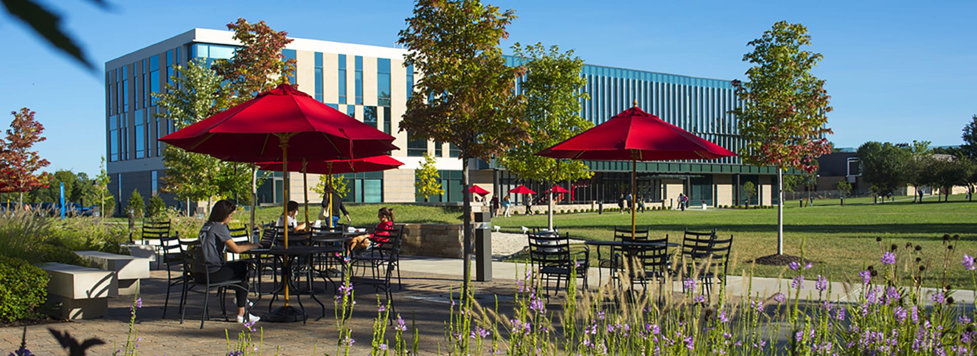 students sitting outside of Gander Hall