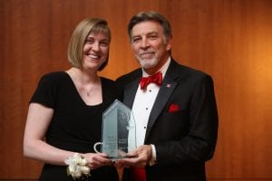 Crystal Weaver receiving an award from Tom Eschen