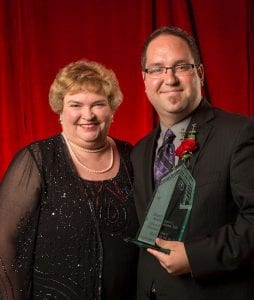 Jason Adams  receiving Maryville Spirit award from a Maryville faculty member