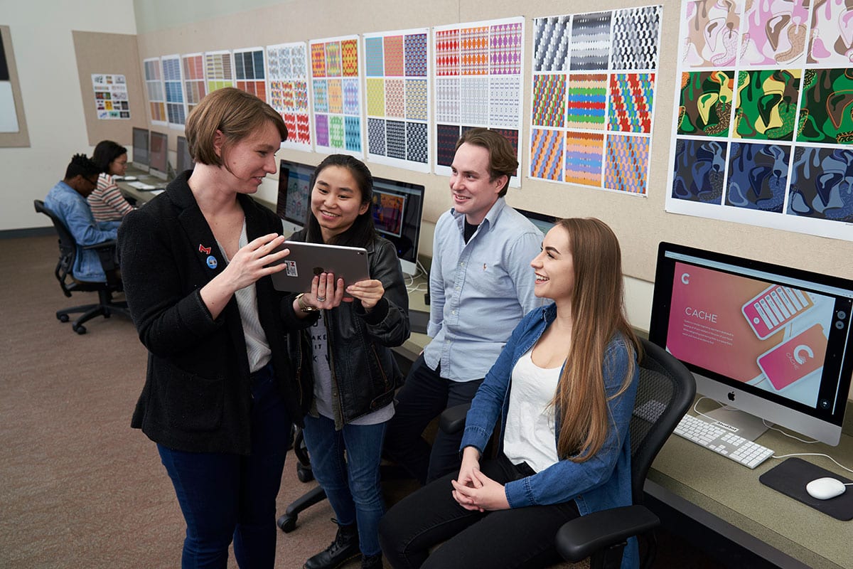 students in graphic design lab with professor