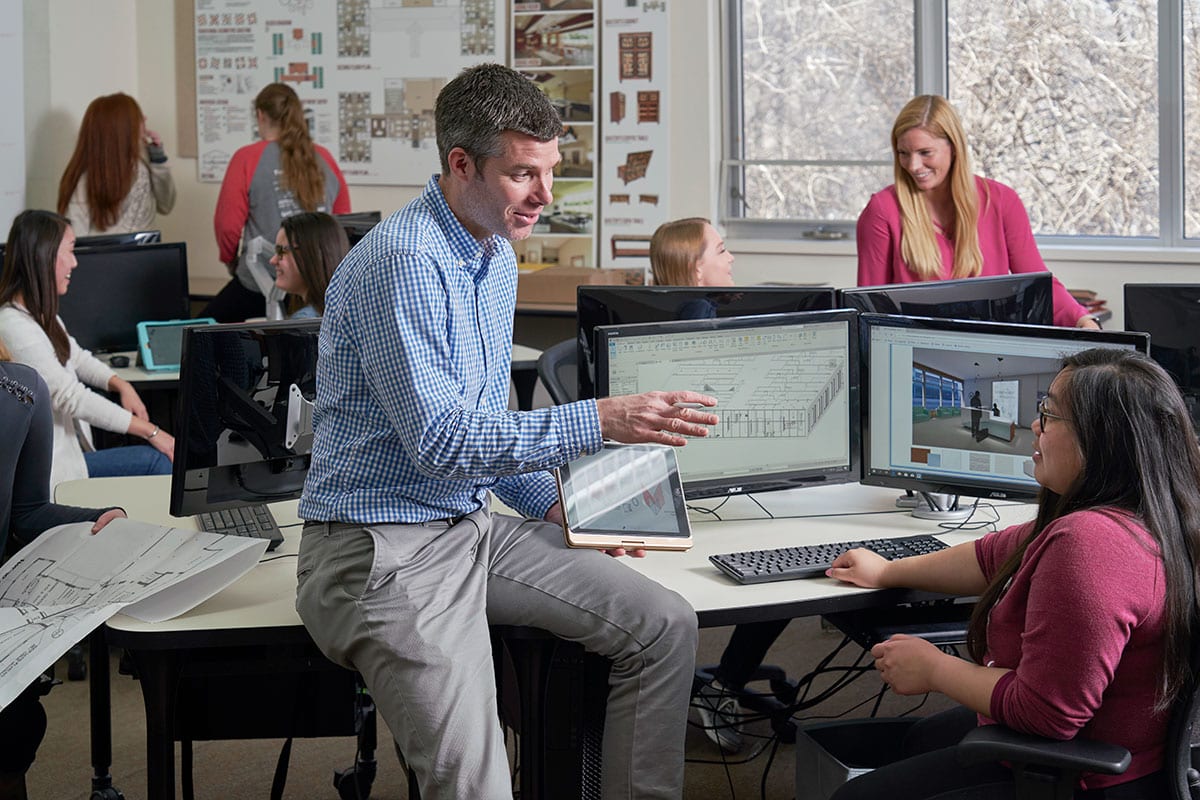 Interior Design professor Mike Kelly discussing a project with a student in class