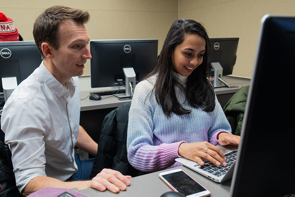 Professor Robbie Beane in class with a student