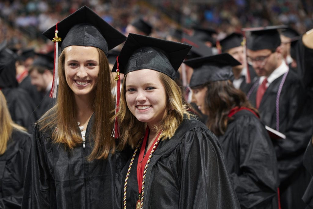 Bascom graduate smiling with friend at commencement