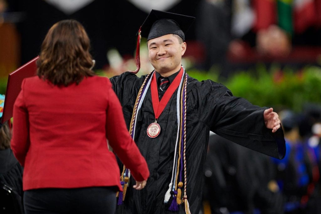 Bascom student getting a hug from friend after graduation