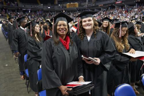 happy graduates pose for camera