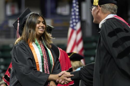 student receiving diploma from board member