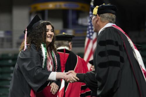student receiving a handshake from board member