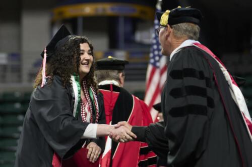 student receiving a handshake from board member