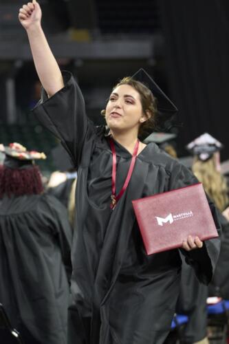 graduate waving to friends and family