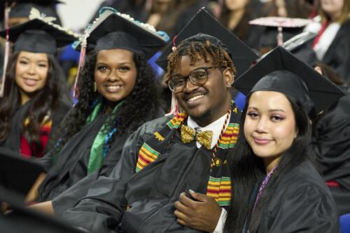 row of students smiling during commencement