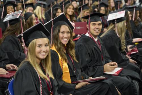 students smiling while listening to speaker