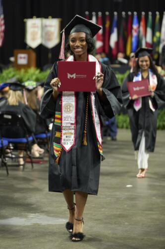 student showing off diploma 