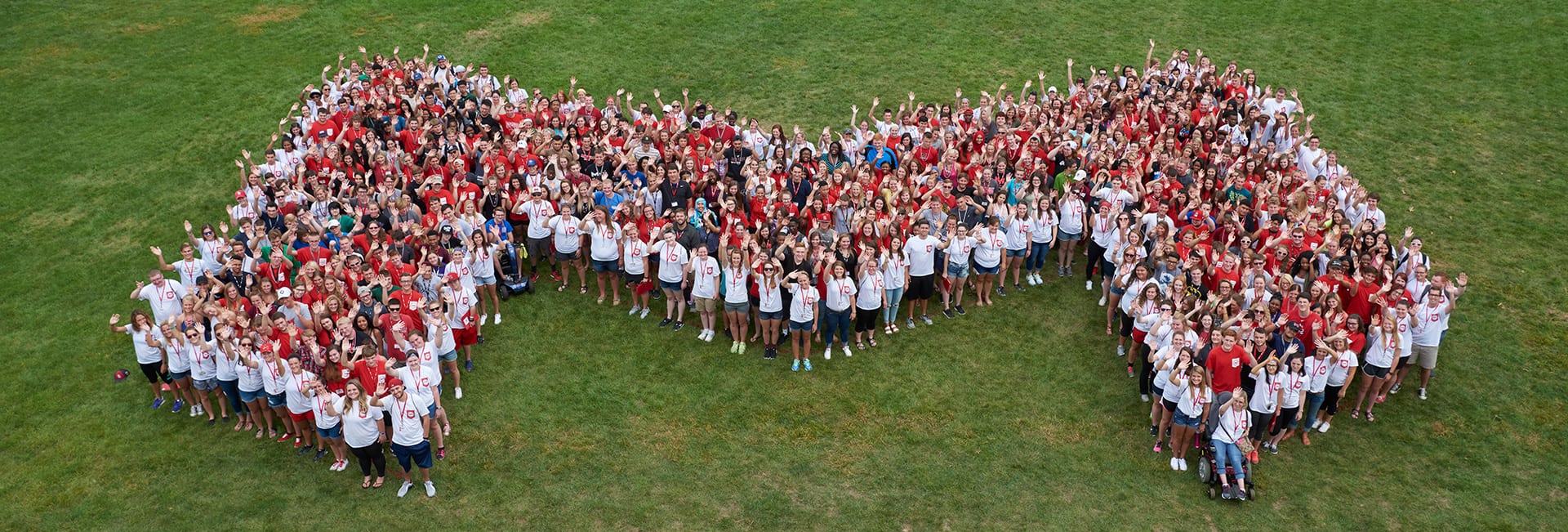 students forming M on commencement lawn