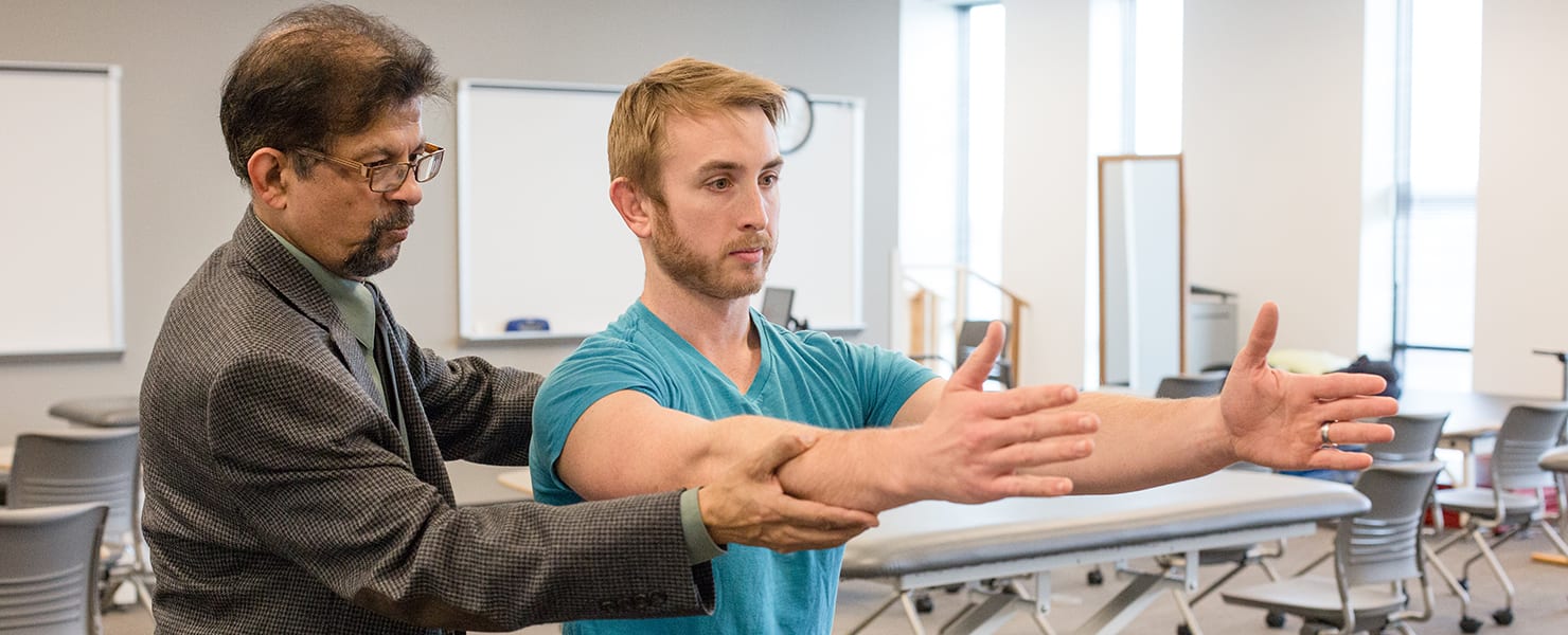 Physical therapy instructor working with student