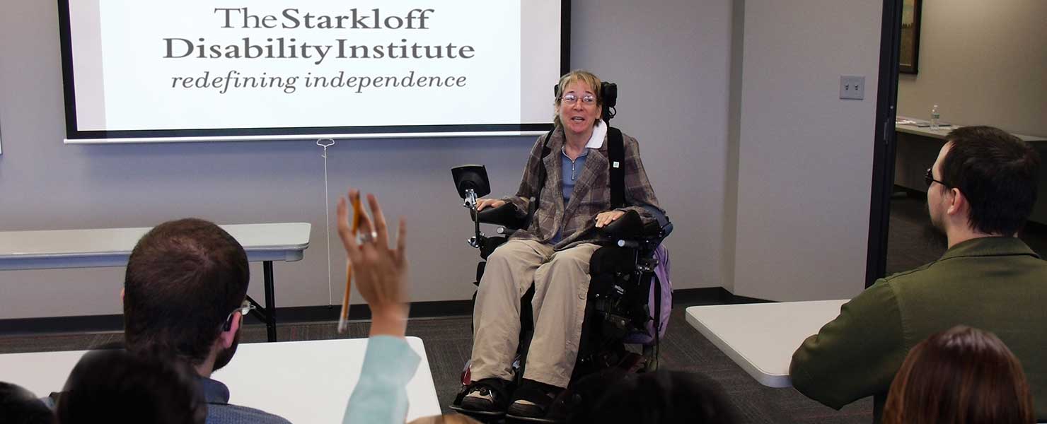 Presenter giving a lecture on disabilities in a classroom