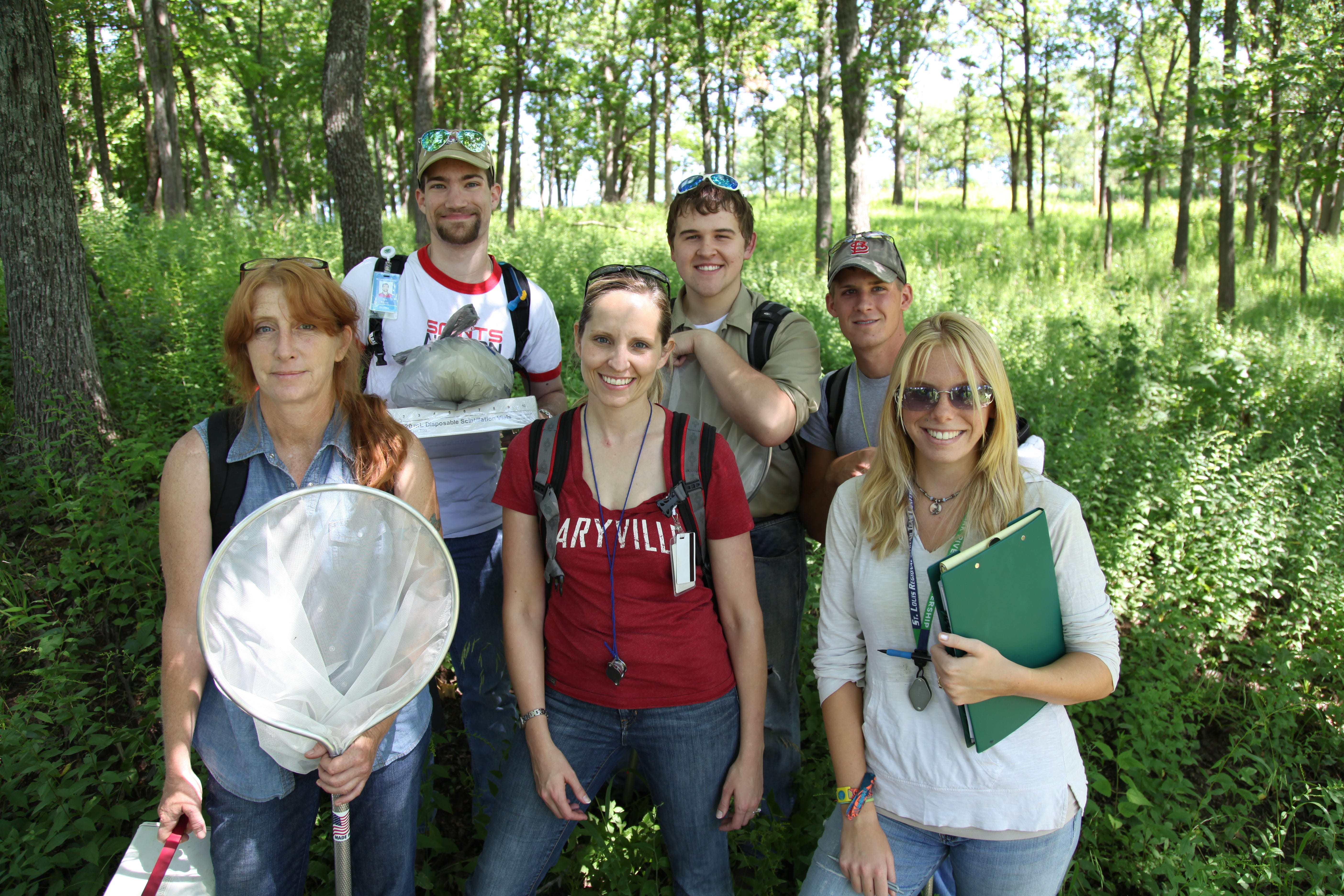 Professor Kyra Krakos outside in a field with students