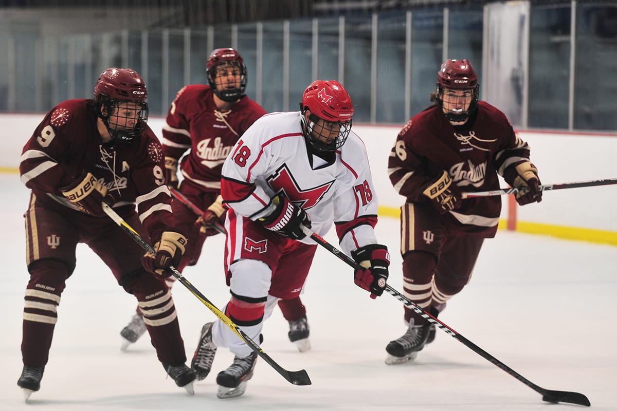 Maryville University ice hockey player skating up the ice