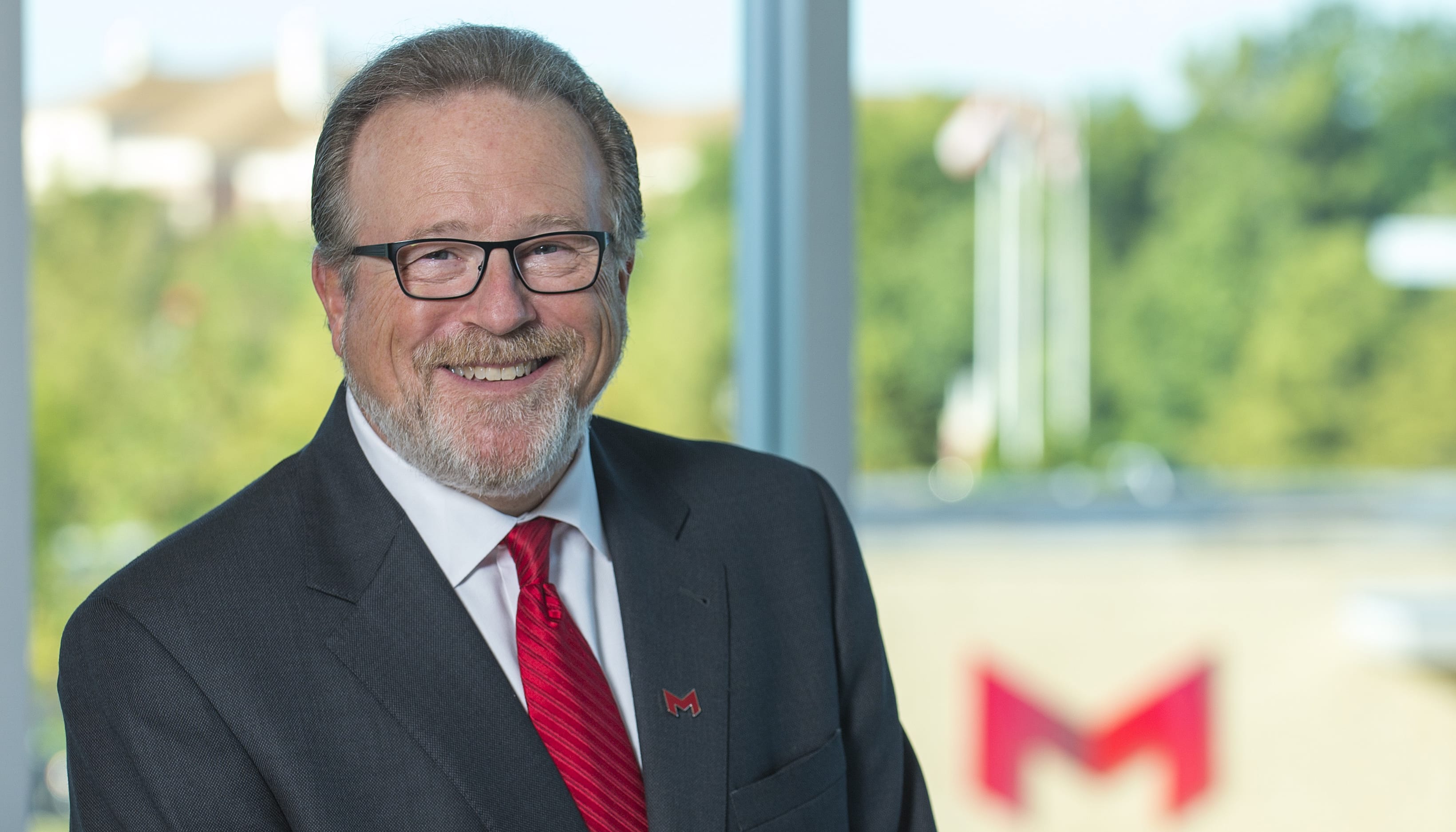 Dr. Lombardi with the Maryville campus in the background.