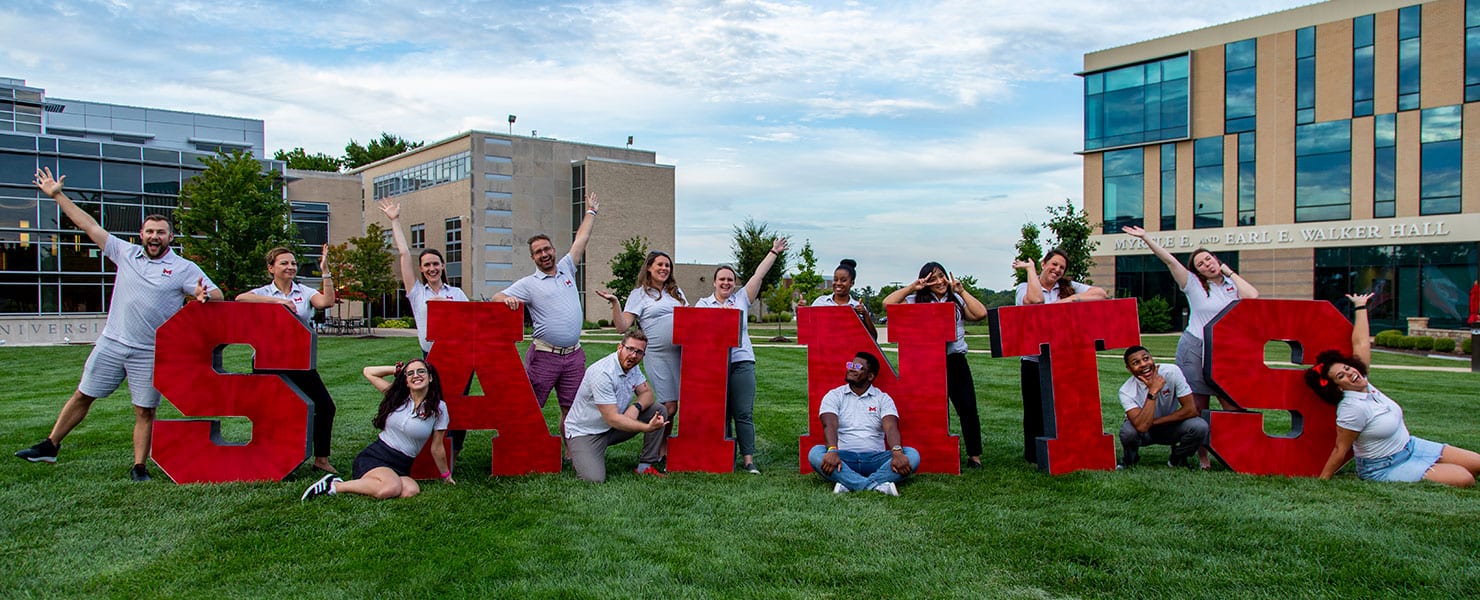 Life Coaches posing on the quad lawn.