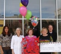 Katherine Conti presented with a check and prototype of her winning screen design