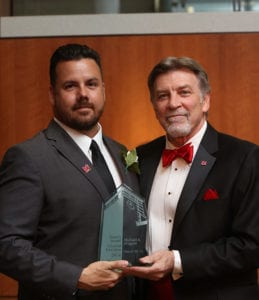 Michael Dragoni accepting a Spirit of Maryville award from Tom Eschen