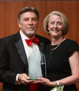 Mary Pfanstiel Heger accepting a Spirit of Maryville award from Tom Eschen