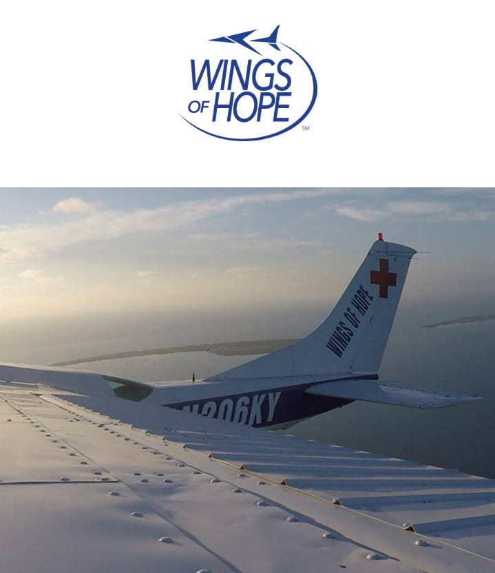 Wings of Hope logo above a plane in the sky