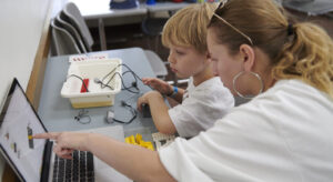 teacher helping student learn about robotics