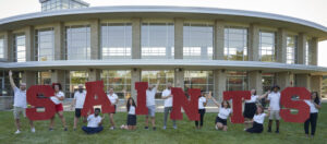 Maryville life coaches holding up Saints letters