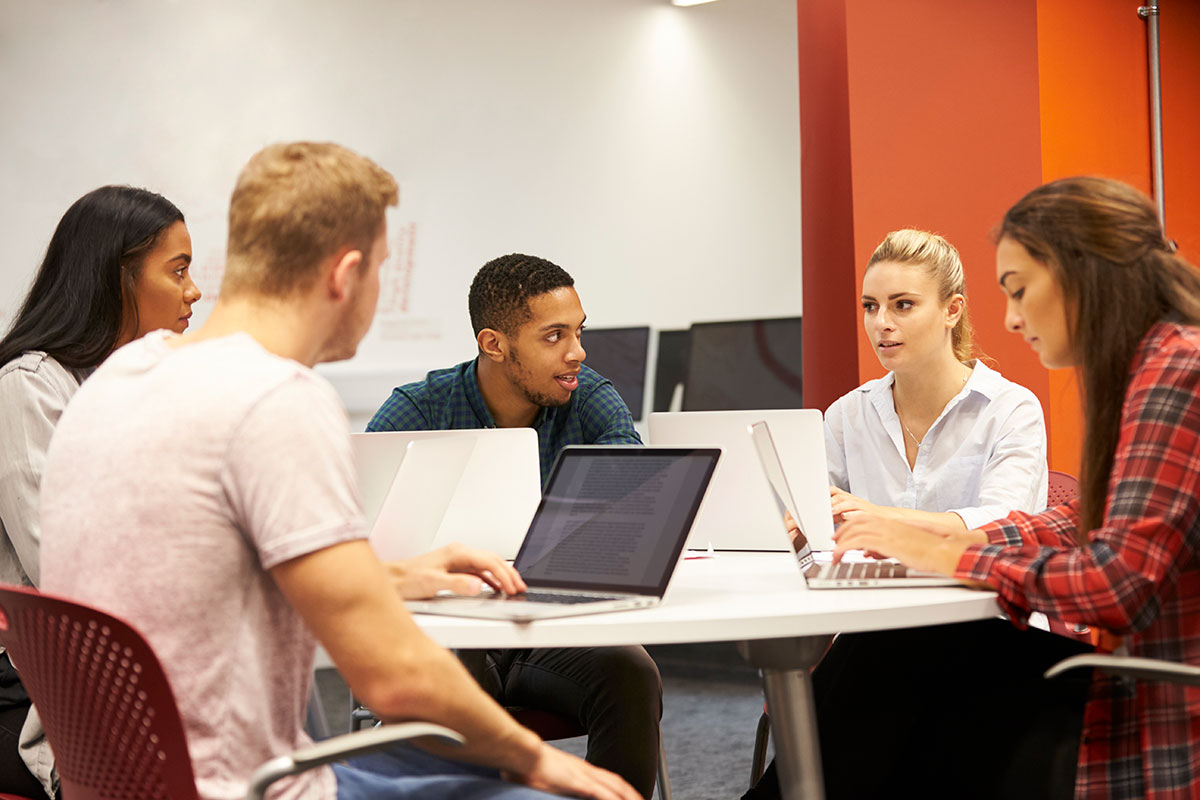 Group of students working at computers together