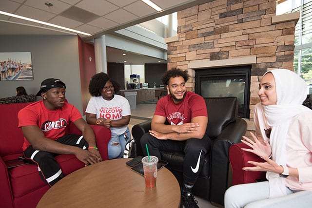 A group of students sitting together and talking.