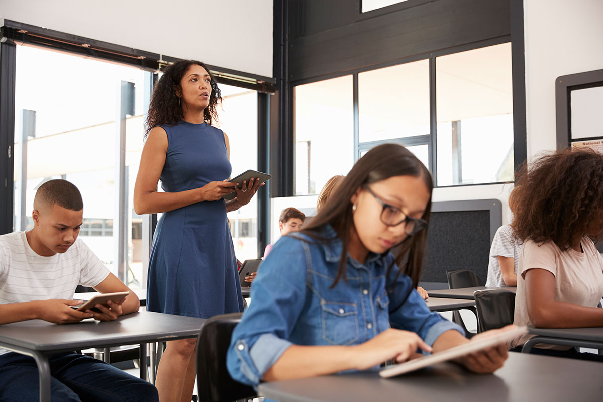 Women teaching students.