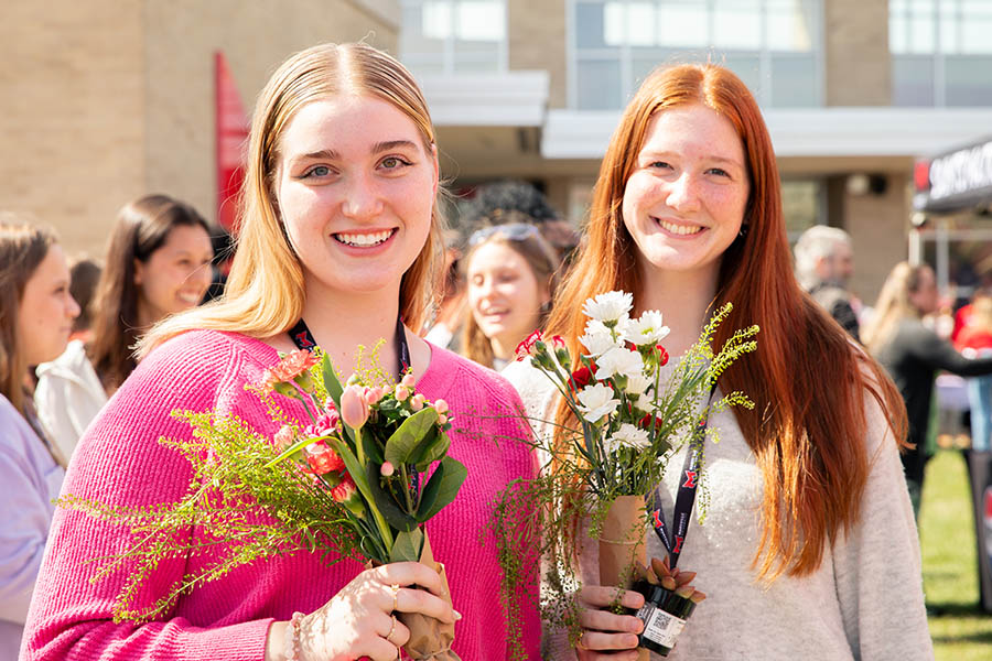 Students holding flowers